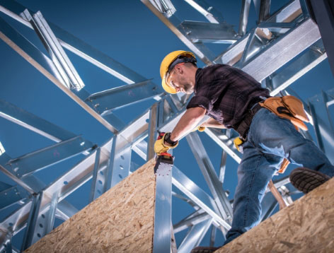 Construction worker assembling a tall building