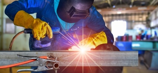 Man welding a piece of steel
