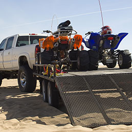 2 ATVs on a new steel utility trailer hooked up to a truck